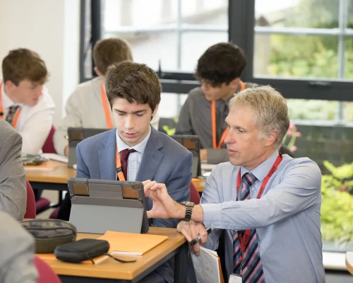 Teacher talking to pupil in class - Nov 23